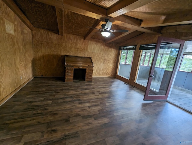 unfurnished living room with wood walls and dark hardwood / wood-style floors