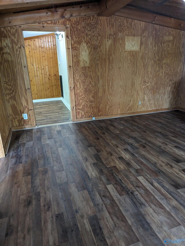 spare room with wood walls and hardwood / wood-style floors