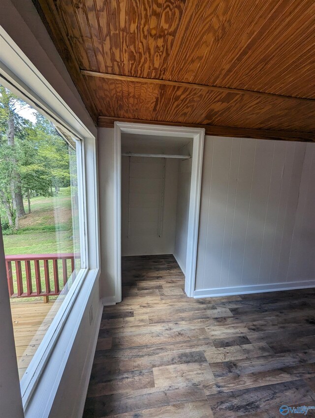 unfurnished bedroom featuring wooden ceiling and hardwood / wood-style flooring