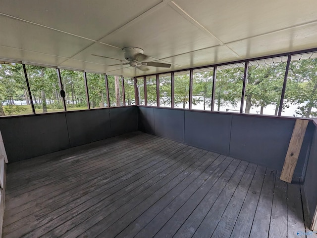 unfurnished sunroom with ceiling fan