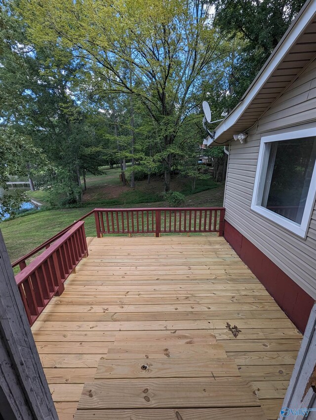 wooden terrace with a yard