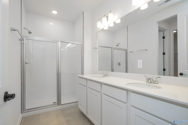 bathroom featuring vanity, walk in shower, and tile patterned floors