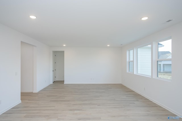 unfurnished room with light wood-type flooring