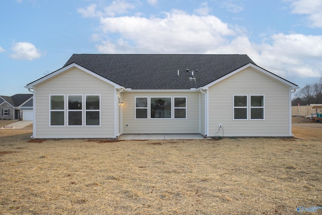 back of property featuring a patio and a yard