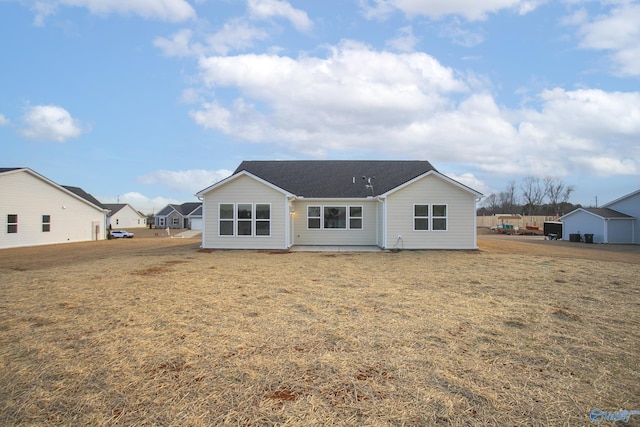 rear view of house with a yard