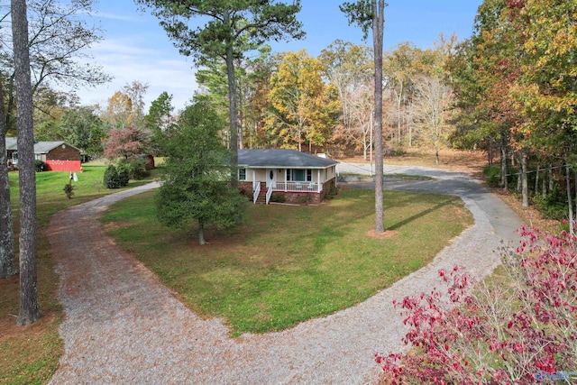 ranch-style house featuring a porch and a front yard