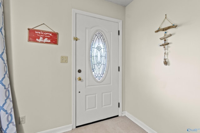 view of carpeted entrance foyer