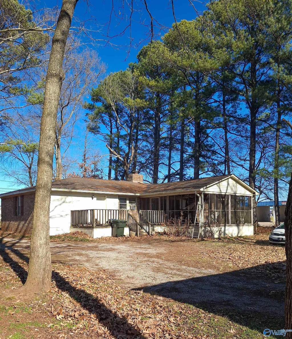 view of front of property featuring a wooden deck and a sunroom