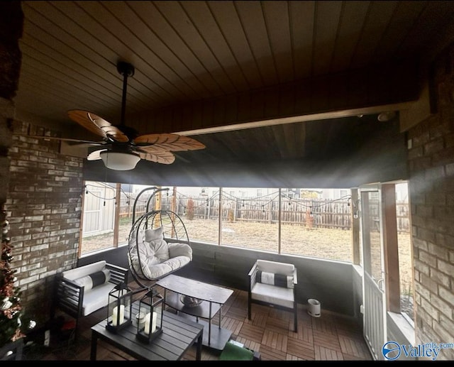 sunroom featuring a ceiling fan