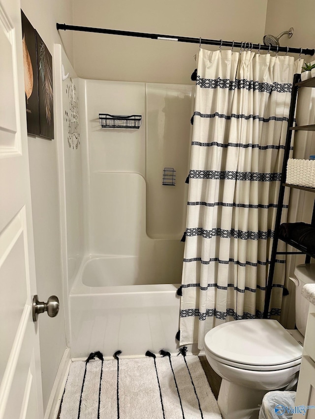 full bathroom featuring shower / bath combo with shower curtain and toilet