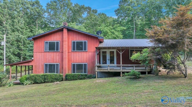 rear view of property featuring a yard and french doors