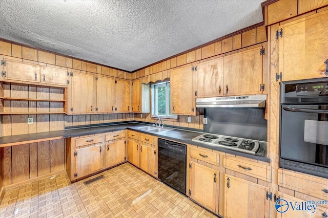 kitchen with sink, ornamental molding, black appliances, a textured ceiling, and wood walls