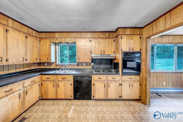 kitchen featuring crown molding, sink, wood walls, and black appliances