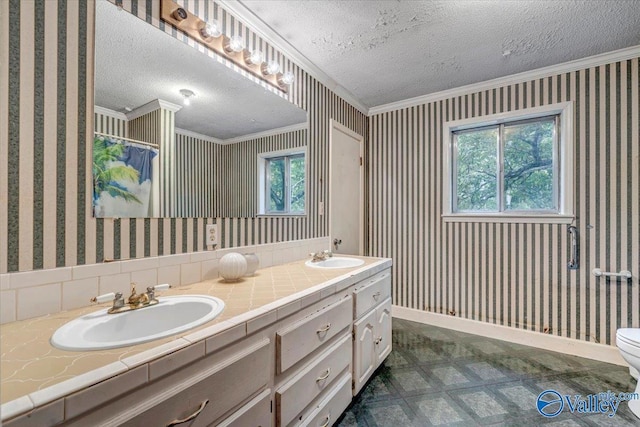 bathroom featuring toilet, vanity, walk in shower, crown molding, and a textured ceiling