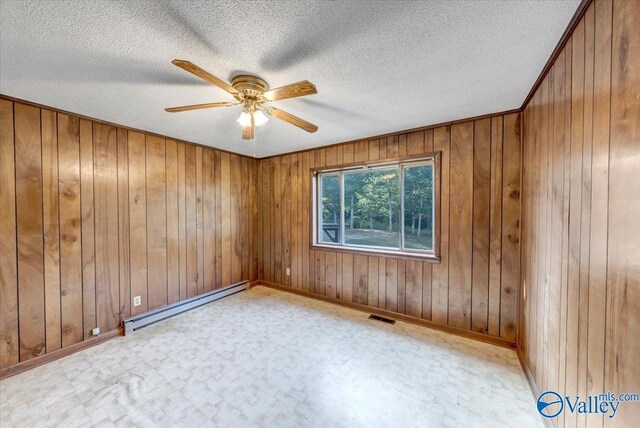 unfurnished room with ceiling fan, a textured ceiling, and baseboard heating