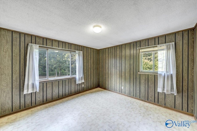 unfurnished room with a textured ceiling