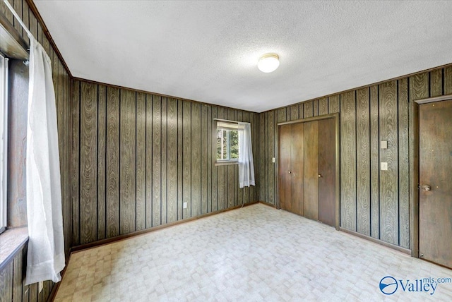 unfurnished bedroom with a closet and a textured ceiling