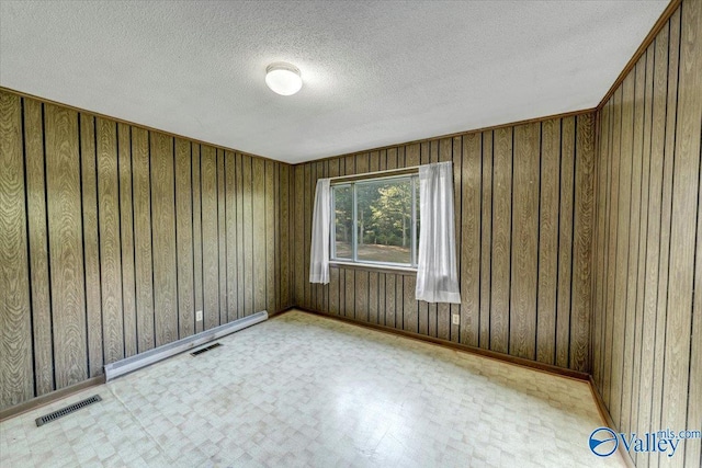 spare room with a textured ceiling