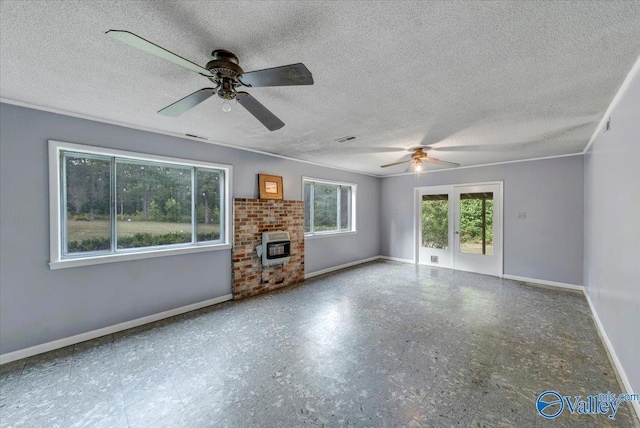 unfurnished living room featuring crown molding, heating unit, ceiling fan, and a textured ceiling