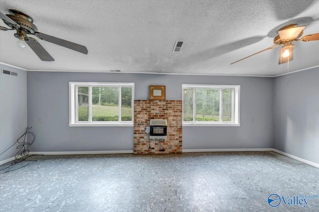 unfurnished living room with a fireplace, a wealth of natural light, and ceiling fan