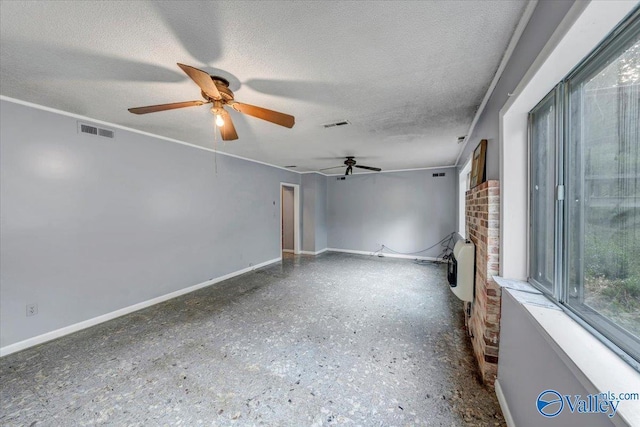 unfurnished room featuring ceiling fan, heating unit, and a textured ceiling