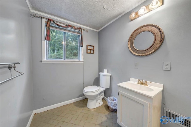 bathroom featuring vanity, crown molding, a textured ceiling, and toilet