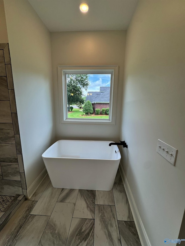 4829 Whorton Bend Rd, Gadsden, AL 35901 - full bath featuring a freestanding tub, marble finish flooring, and recessed lighting