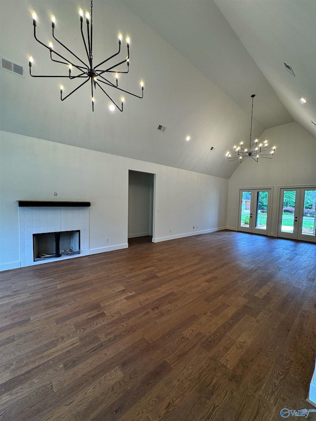 4829 Whorton Bend Rd, Gadsden, AL 35901 - unfurnished living room featuring a chandelier, high vaulted ceiling, dark wood-style floors, and a tile fireplace