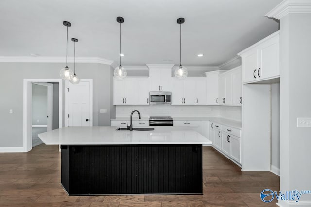kitchen featuring decorative backsplash, light countertops, ornamental molding, stainless steel appliances, and a sink