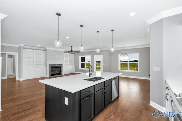 kitchen with a center island with sink, dishwasher, dark wood-type flooring, sink, and ceiling fan