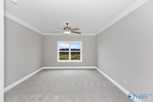 empty room featuring a ceiling fan, ornamental molding, carpet, and baseboards