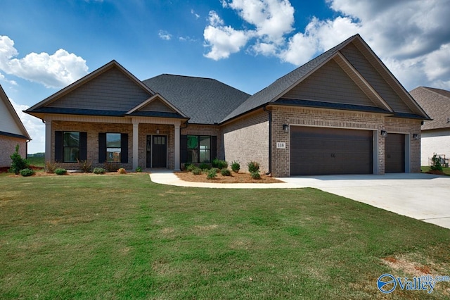 craftsman-style home featuring roof with shingles, driveway, a front yard, brick siding, and a garage