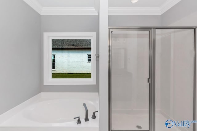 bathroom with a bath, crown molding, and a shower stall