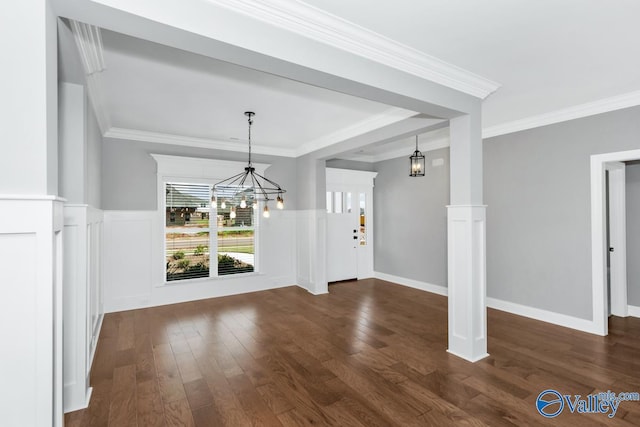 unfurnished dining area featuring dark wood-style flooring, ornamental molding, and a chandelier