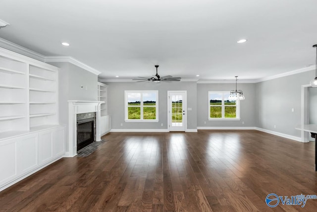 unfurnished living room with dark wood finished floors, a high end fireplace, baseboards, ceiling fan with notable chandelier, and ornamental molding