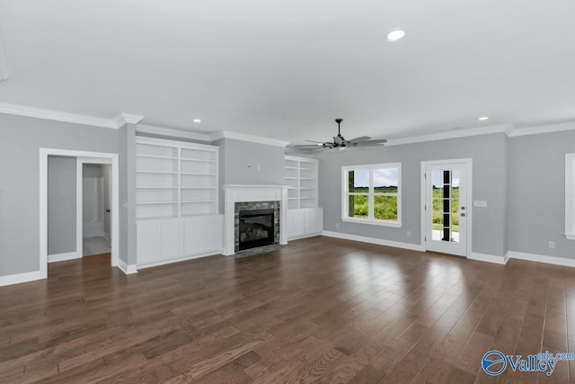 unfurnished living room featuring crown molding, dark wood-type flooring, ceiling fan, and a high end fireplace