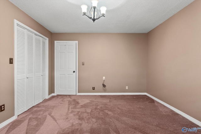 interior space featuring a textured ceiling and a chandelier