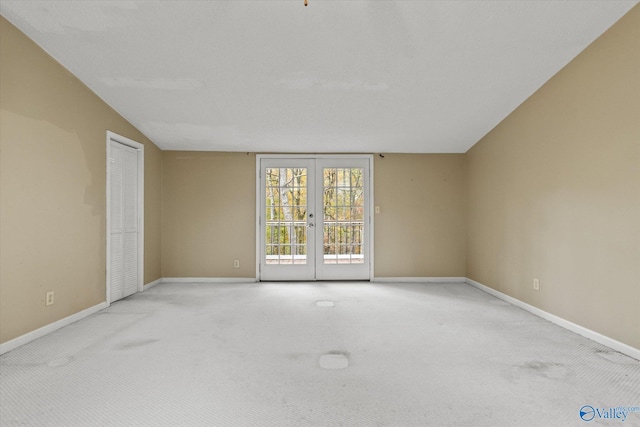 carpeted spare room with french doors