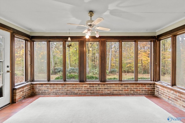 unfurnished sunroom with ceiling fan