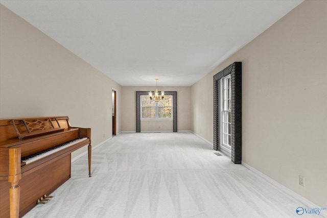 hallway featuring light colored carpet and an inviting chandelier