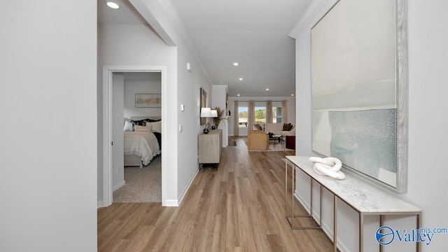 hallway with french doors, light hardwood / wood-style floors, and ornamental molding