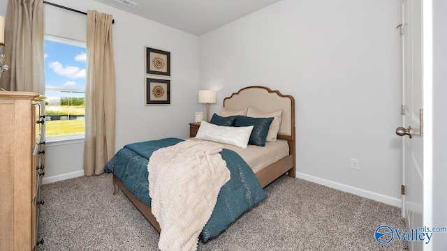 bedroom featuring light colored carpet