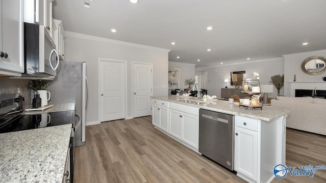 kitchen with white cabinetry, sink, light stone counters, a kitchen island with sink, and appliances with stainless steel finishes