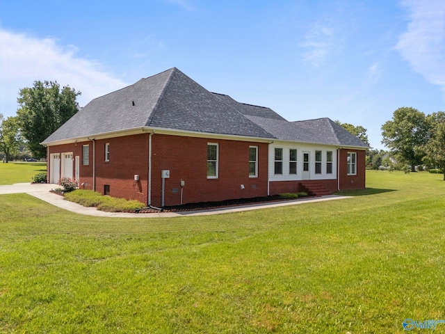 10214 New Cut Rd, Athens, AL 35611 - view of side of home with brick siding, a lawn, roof with shingles, driveway, and an attached garage
