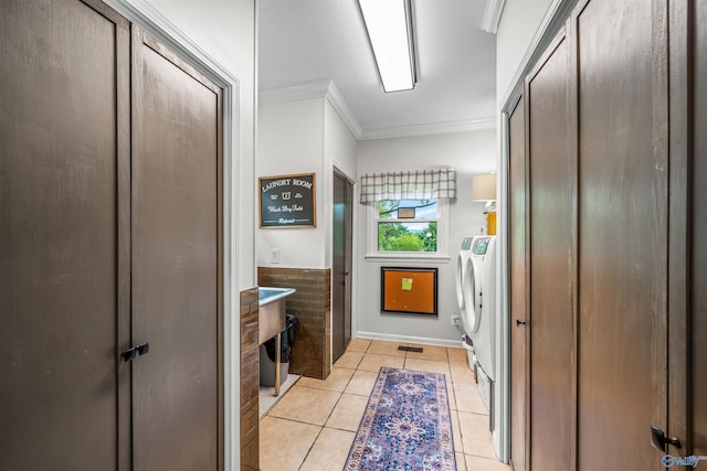 bathroom featuring washer and clothes dryer, ornamental molding, and tile patterned floors