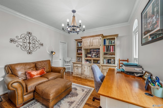 office space featuring light hardwood / wood-style floors, ornamental molding, and an inviting chandelier