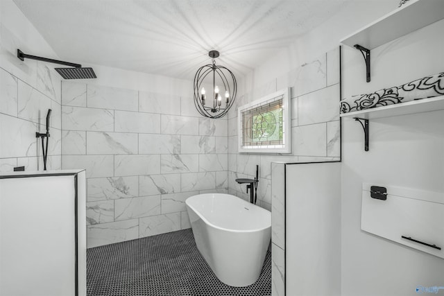 bathroom featuring tile walls, a bathing tub, and a chandelier