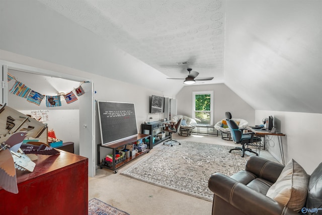 carpeted living room featuring ceiling fan, a textured ceiling, and lofted ceiling