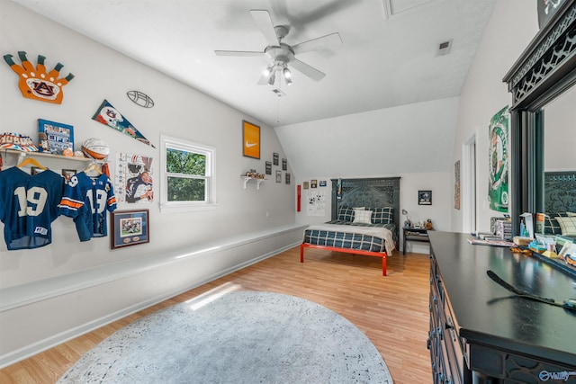 bedroom with ceiling fan, light hardwood / wood-style flooring, and lofted ceiling