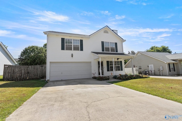 traditional-style home featuring covered porch, a garage, fence, driveway, and a front lawn